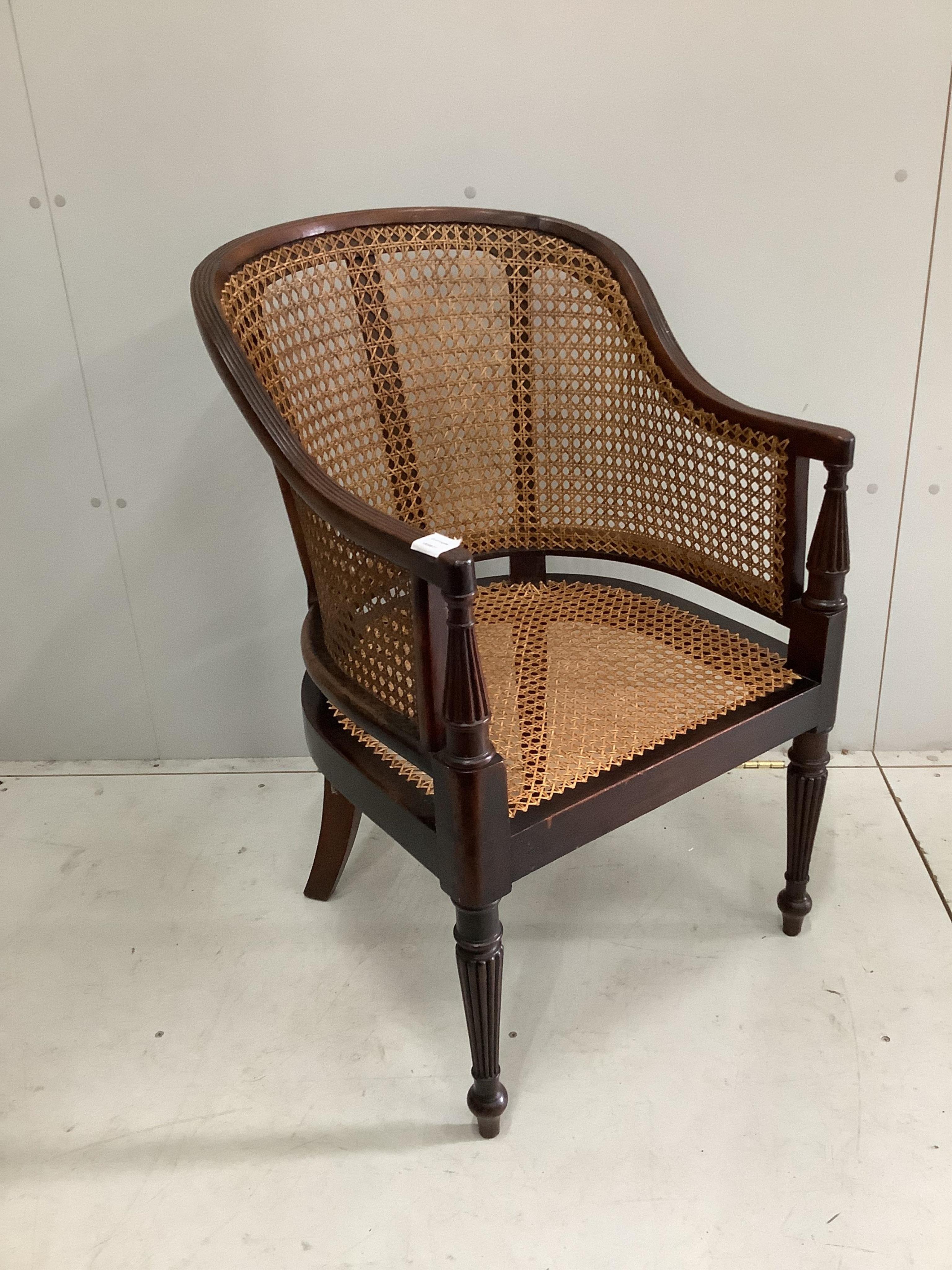 A Regency style mahogany bergère armchair with later caning, width 56cm, height 87cm. Condition - fair to good